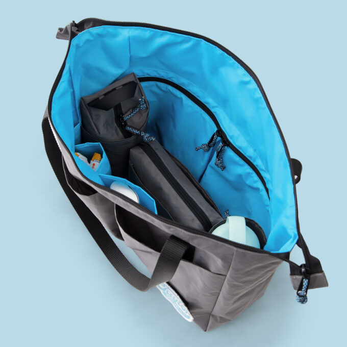 Tess Tote sewing pattern packed and open, showing interior pockets and water bottle pocket organization
